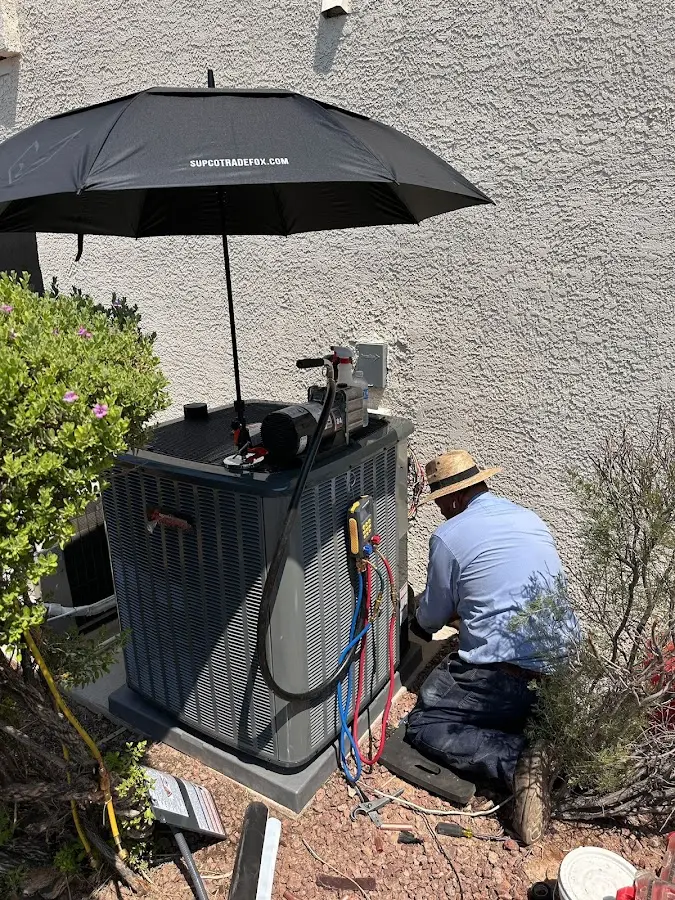 HVAC technician performing outdoor AC maintenance in Sayreville